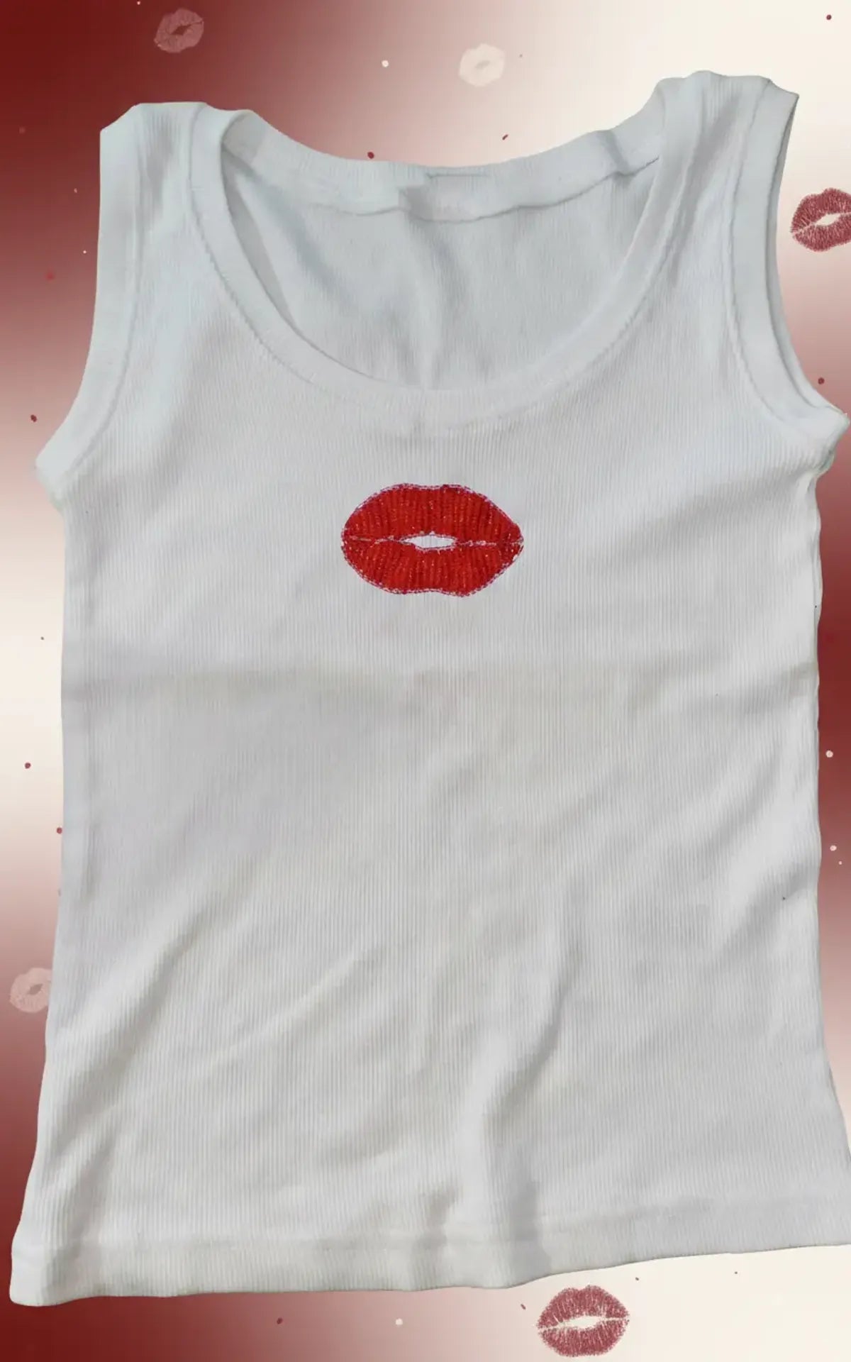 Woman wearing a CherryPop red lips hand-beaded cotton rib tank top with a fitted sleeveless silhouette.
