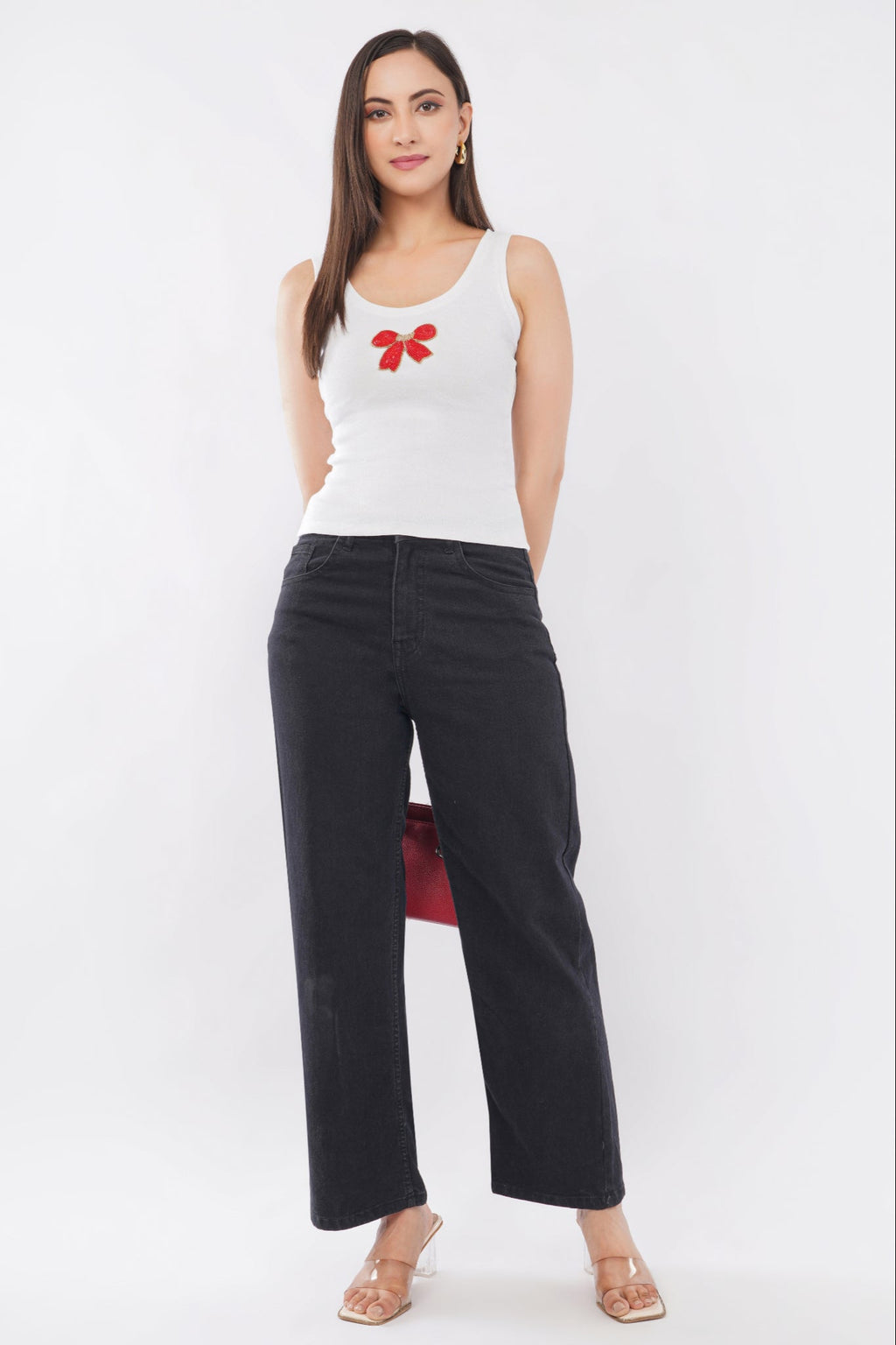 Woman wearing a white cotton ribbed tank top featuring a handcrafted red bow beadwork motif by CherryPop