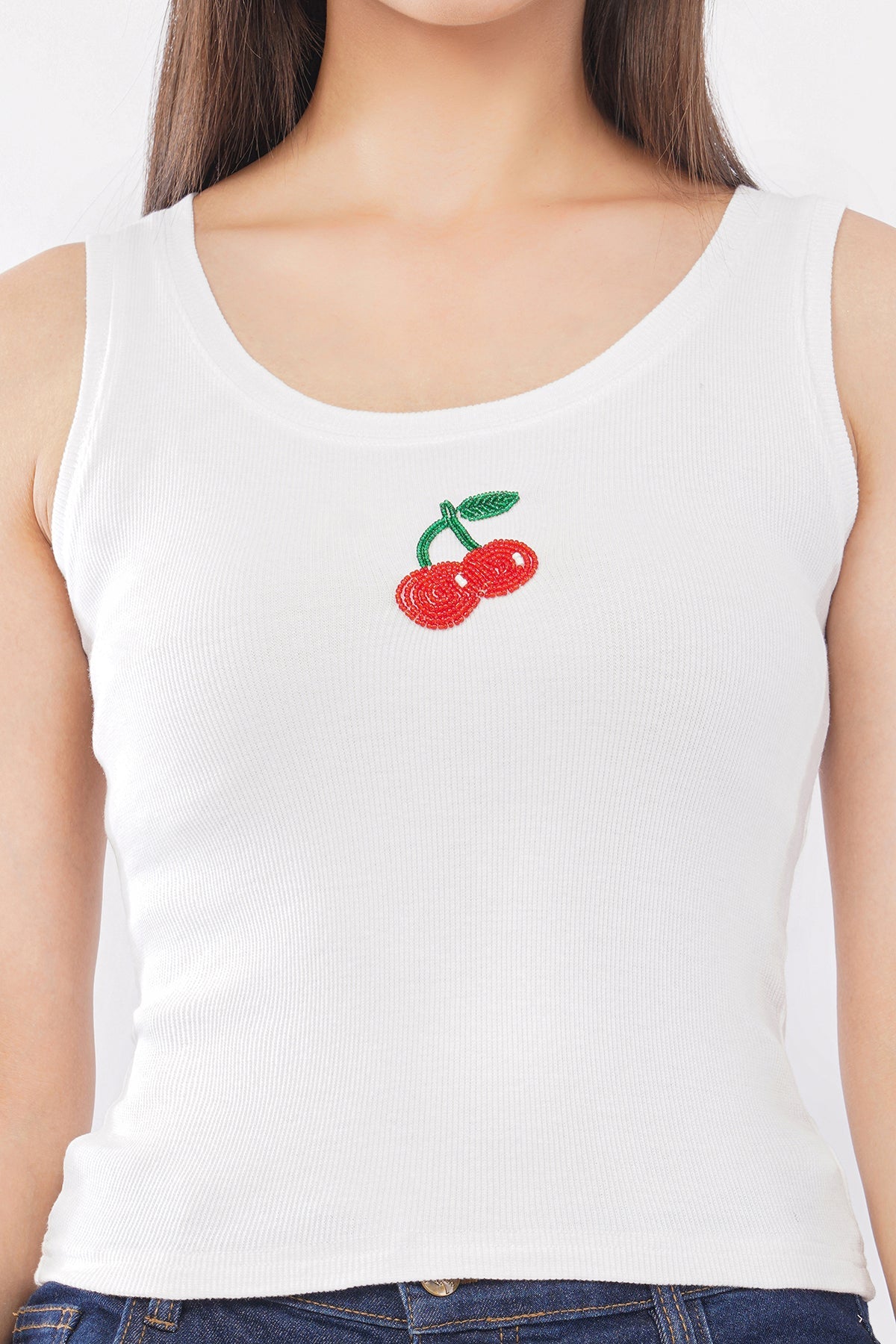 White tank top with cherry design worn by a person