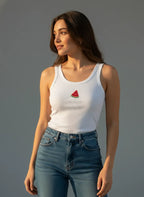 Woman wearing a white tank top with a watermelon design against a gray background